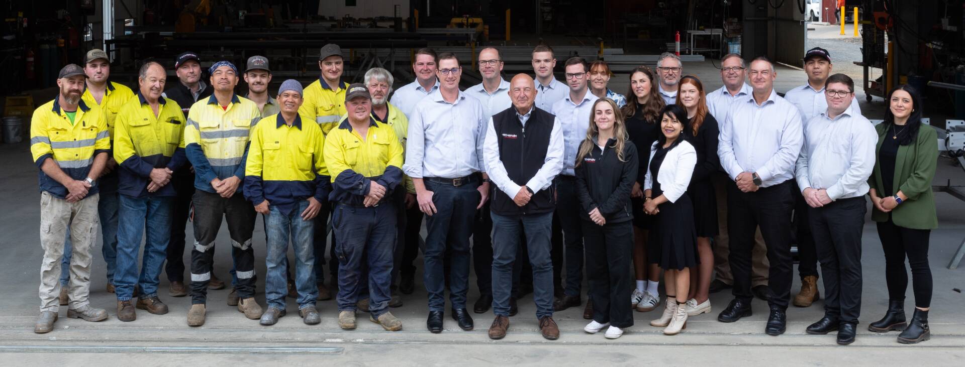 TechSpan team photo 2026 standing in the manufacturing shed