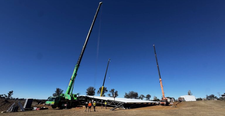 TechSpan structural steel building under construction in Uralla NSW, with cranes and installation crews on site.