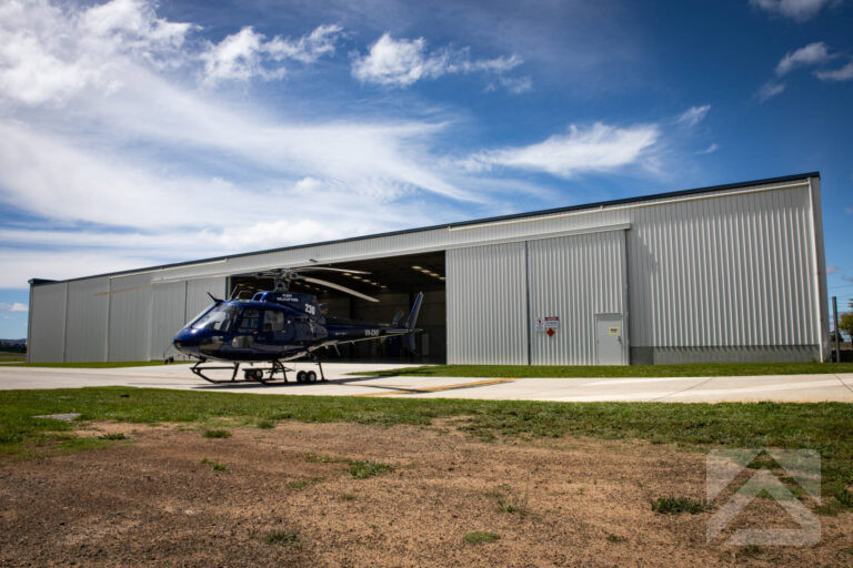 Fleet Helicopters helicopter outside a TechSpan aircraft hangar in Armidale, NSW.