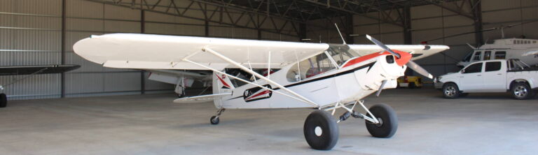 Aircraft stored inside a large clear-span steel aircraft hangar