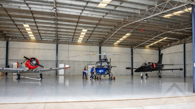 Two aeroplanes and a helicopter inside the Fleet Helicopters hangar in Armidale, NSW.